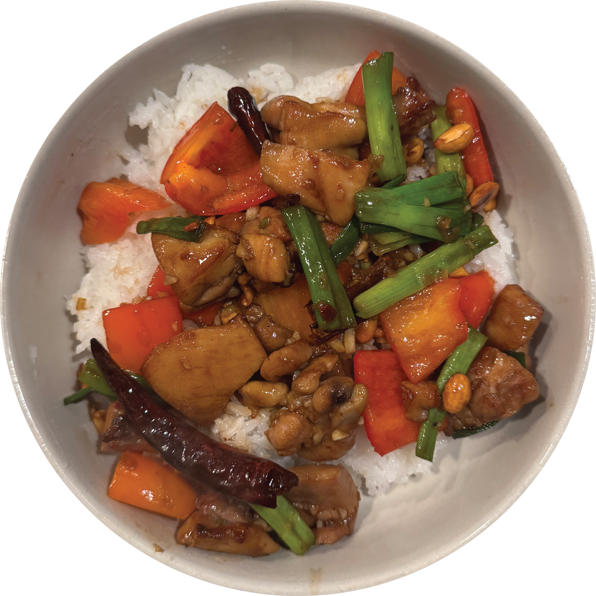 A bowl of kung pao chicken over white rice