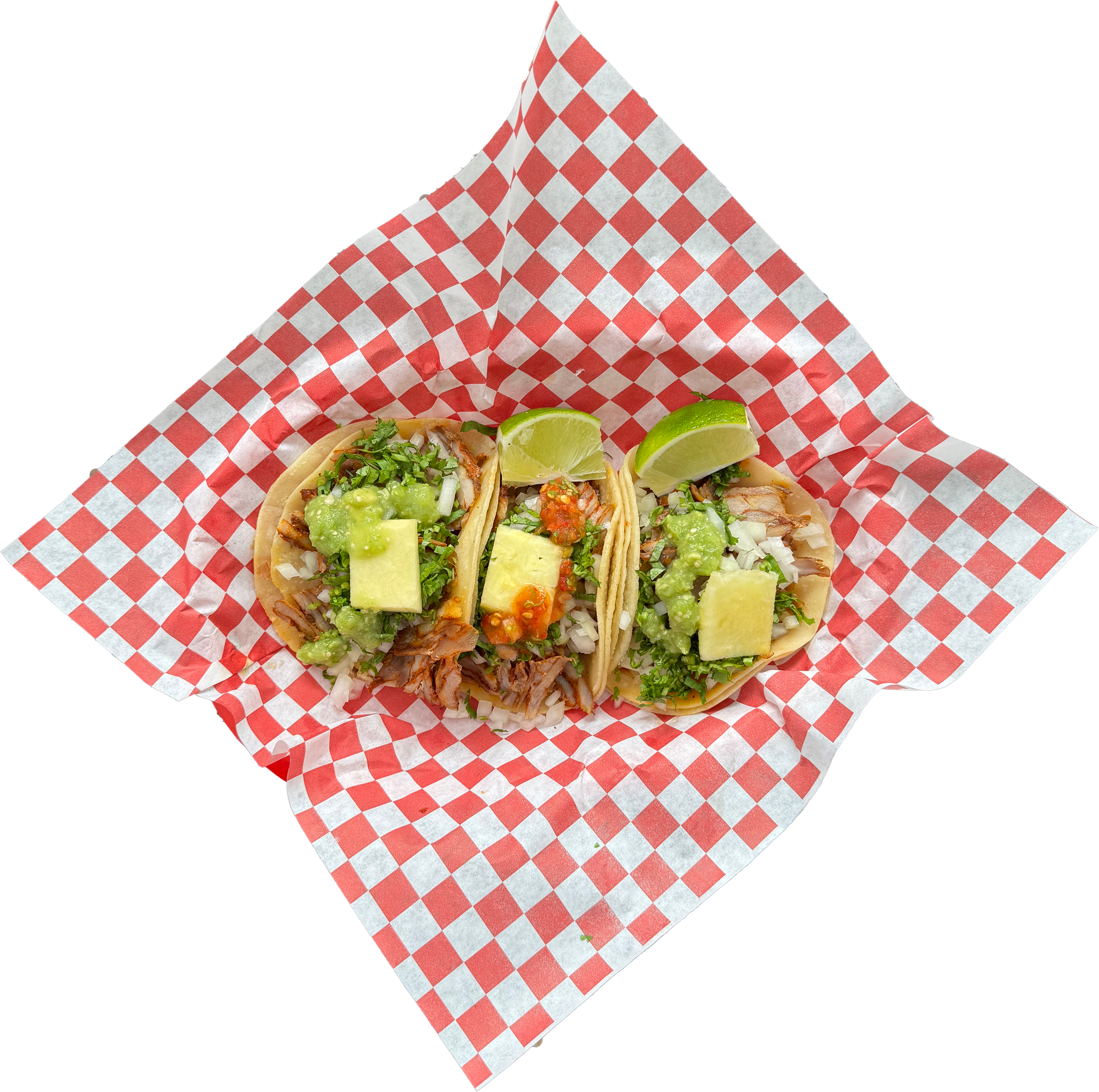 Three al pastor tacos with cilantro, onion, pineapple and salsa in a basket.